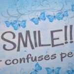 Schild  SMILE - IT CONFUSES PEOPLE